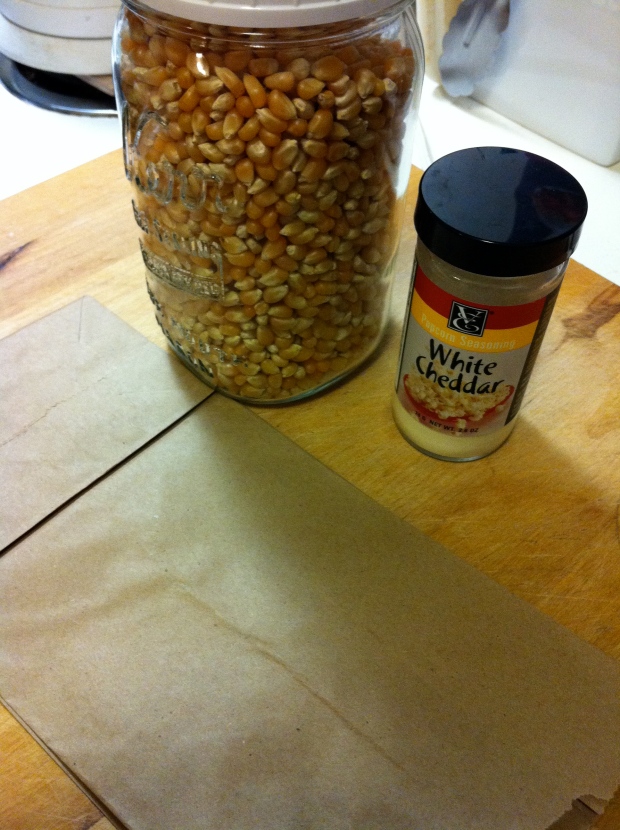Three ingredients: popcorn seeds, brown paper lunch bag, and seasoning of choice.